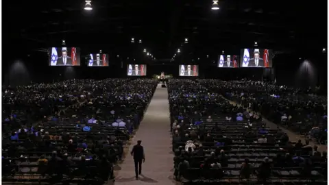 Reuters Mourners seated in the convention hall