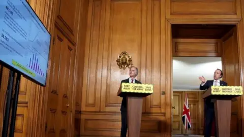 PA Media Matt Hancock and PHE director of health improvement John Newton