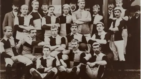 Cardiff Rugby Museum Norman Biggs sat backwards on a chair