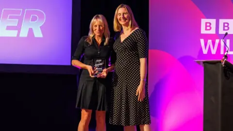 Tamzyn Long (L) receiving the Environmental Award alongside BBC Radio Wiltshire presenter Jill Misson