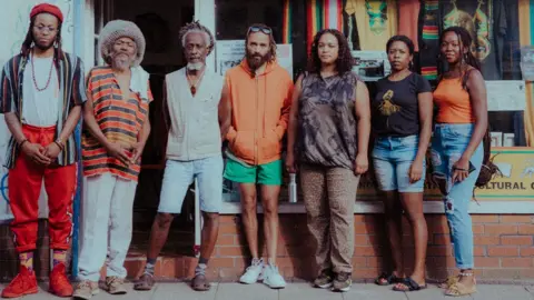 Khali Ackford Solomon Ogunmefun-Brooker, (left) and Ras Bandele Selassie (second left) with other community members