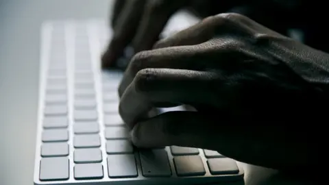 Getty Images Hands at a keyboard