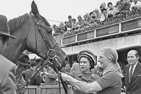 Getty Image/Evening Standard Queen Elizabeth II with her racehorse Highclere, after the horse won the 1000 Guineas Stakes at Newmarket, UK, 2nd May 1974