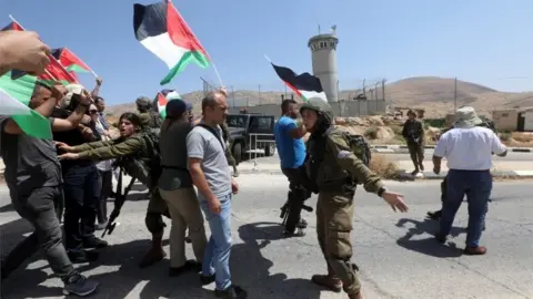 EPA Palestinians and Israeli troops at Tayaseer checkpoint (06/06/22)