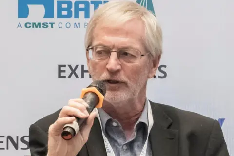 Expana Steve Wateridge holding a microphone