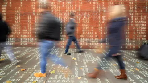 Getty Images Graphic of people walking against backdrop of ones and noughts