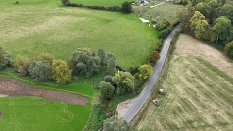 Environment Agency A bird's eye view of the new wetland. It is very green with grass and trees everywhere 