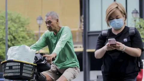 EPA Woman wearing face mask in Singapore