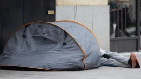 Getty Images Homeless person in a tent