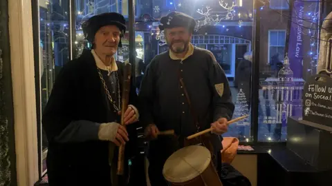 Shannon Eustace/BBC Two men in Tudor costume, one with a recorder and one with a drum