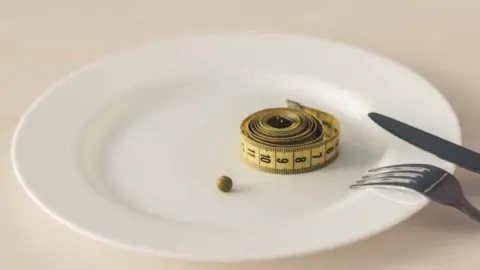 Getty Images A plate with a single pea and a tape measure