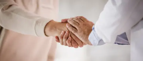 Getty Images A patient with Parkinson's shaking a doctor's hand (stock image)