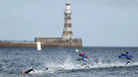 PA Media Athletes taking part in the swim leg of the triathlon at Sunderland last month