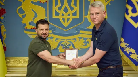 Government of Ukraine Ukraine President Volodymyr Zelensky and BAE Systems Chief Executive Charles Woodburn.