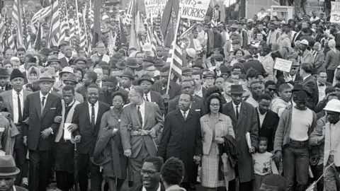 Bettmann/Getty Images Dr. Martin Luther King (center) leads an estimated 10,00 or more civil rights marchers out on the last leg of their Selma-to Montgomery march - 25 March 1965