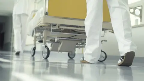 Getty Images Wheeling a patient through a hospital