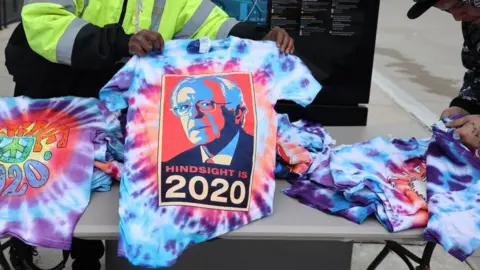 Getty Images A t-shirt featuring Mr Sanders' picture bears the words 'Hindsight is 2020'