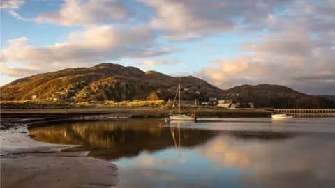 Barbara Fuller Boats lay still at sundown on the magnificent Mawddach Estuary, a serene scene captured by Barbara Fuller