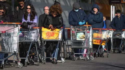 Getty Images Sainsbury's shoppers queueing up