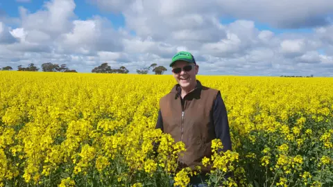 CHRIS KELLY Victorian grain grower Chris Kelly standing in a field of canola in his farm in the southern Mallee region