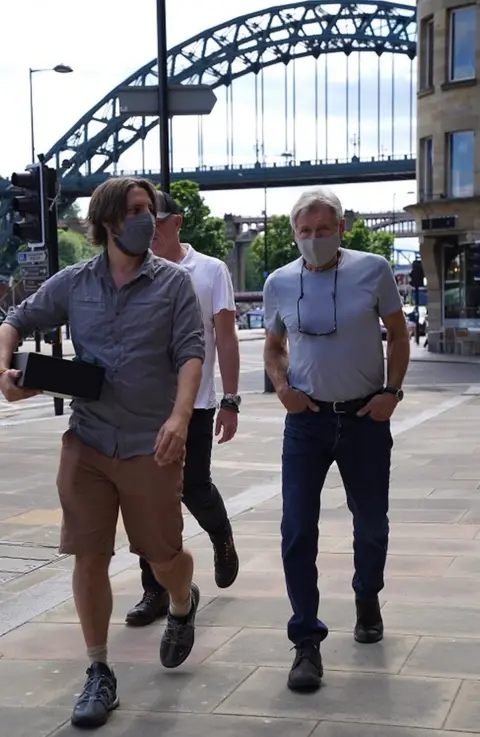 Terry Blackburn Harrison Ford, wearing a face mask, on Newcastle Quayside with the Tyne Bridge in the background