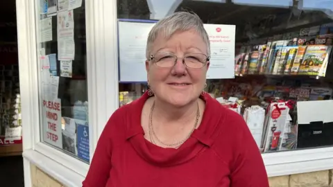 Jennie smiles outside the post office on her last day