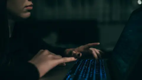 Getty Images Anonymous woman at laptop