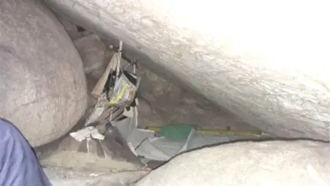Police handout Small cave between large boulders