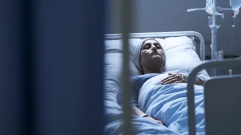 Getty Images Woman receiving cancer treatment