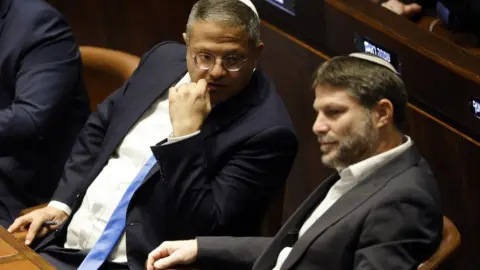 EPA Otzma Yehudit (Jewish Power) party leader Itamar Ben-Gvir (L) and Religious Zionism leader Bezalel Smotrich (R) attend a special session of the Israeli Knesset in Jerusalem on 29 December 2022