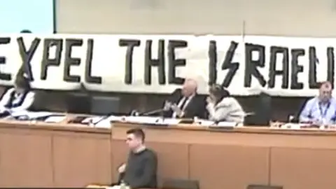 the banner unveield at derry council by pro palestine protestors