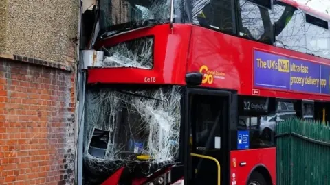 Three children and two adults have been taken to hospital after a double-decker bus hit a shop in north-east London.