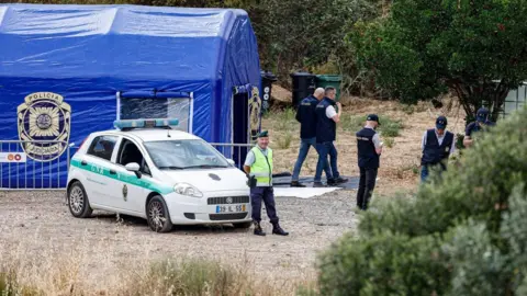 EPA/Shutterstock Police have cordoned off a stretch of the reservoir and set up blue tents to conduct the search