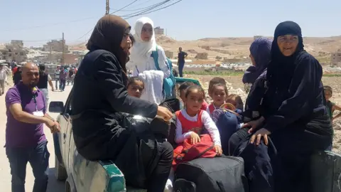 AFP/Getty Syrians arrive at edge of Arsal to board buses