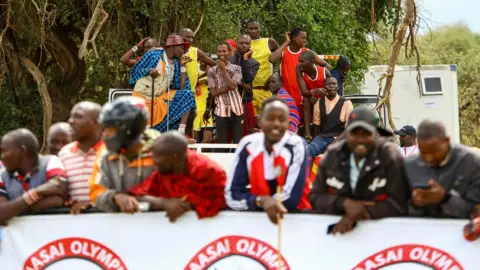 EPA Maasai spectators watch the sporting event from afar