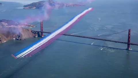 Royal Air Force Red Arrows flying over the Golden Gate Bridge in San Franciso