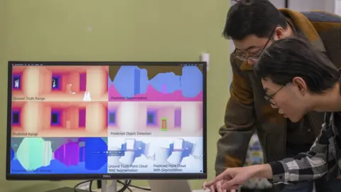 Sylvia Zhang shows 3D images of a room created by a screen radio vision system.