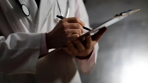 Getty Images A generic picture of a doctor with a clipboard