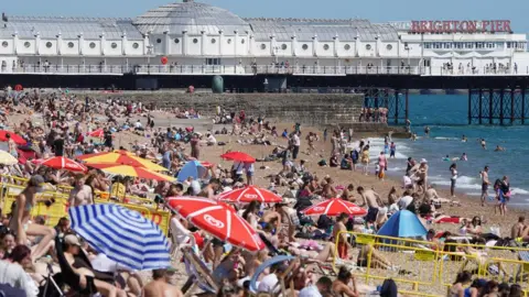 PA Media Crowds on Brighton beach