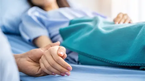 Getty Images Person holding woman's hand