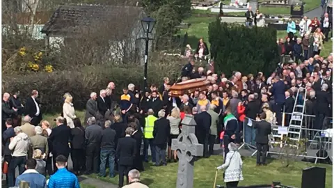 BBC Mourners paying their respects to 'Big Tom' after his funeral in County Monaghan on Friday morning