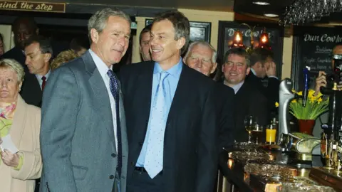 PA Media President George W Bush and Prime Minister Tony Blair in a pub in Sedgefield in 2003