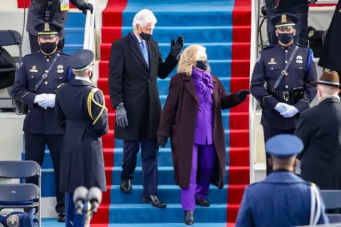 Rob Carr / Getty Images Bill Clinton and Hillary Clinton walk down steps together to find their seat