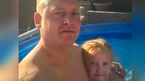 Family photo Ruby with her dad Jamie in a swimming pool
