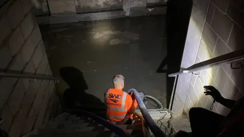 Cllr Rohit K Dasgupta A contractor pumps water from the basement in a building at Hallsville Quarter