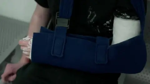 A patient with their arm in a sling