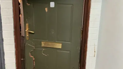 North Yorkshire Police The door of the property after police forced entry to execute the warrant