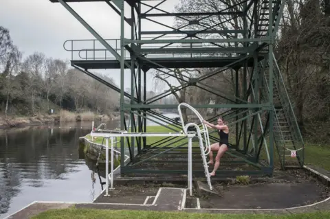 James Beck A woman climbs the diving board