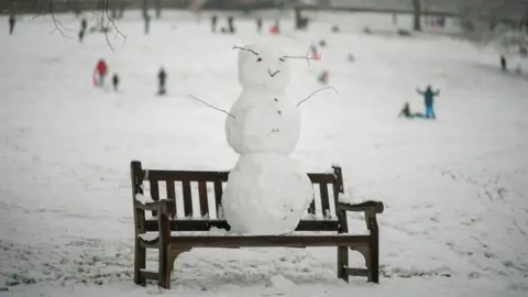 Getty Images Snowman on a bench