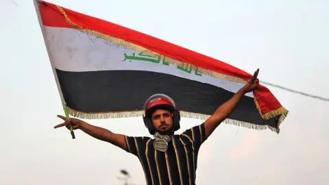 AFP An Iraqi protester poses with a national flag during a demonstration in Baghdad on 29 October 2019